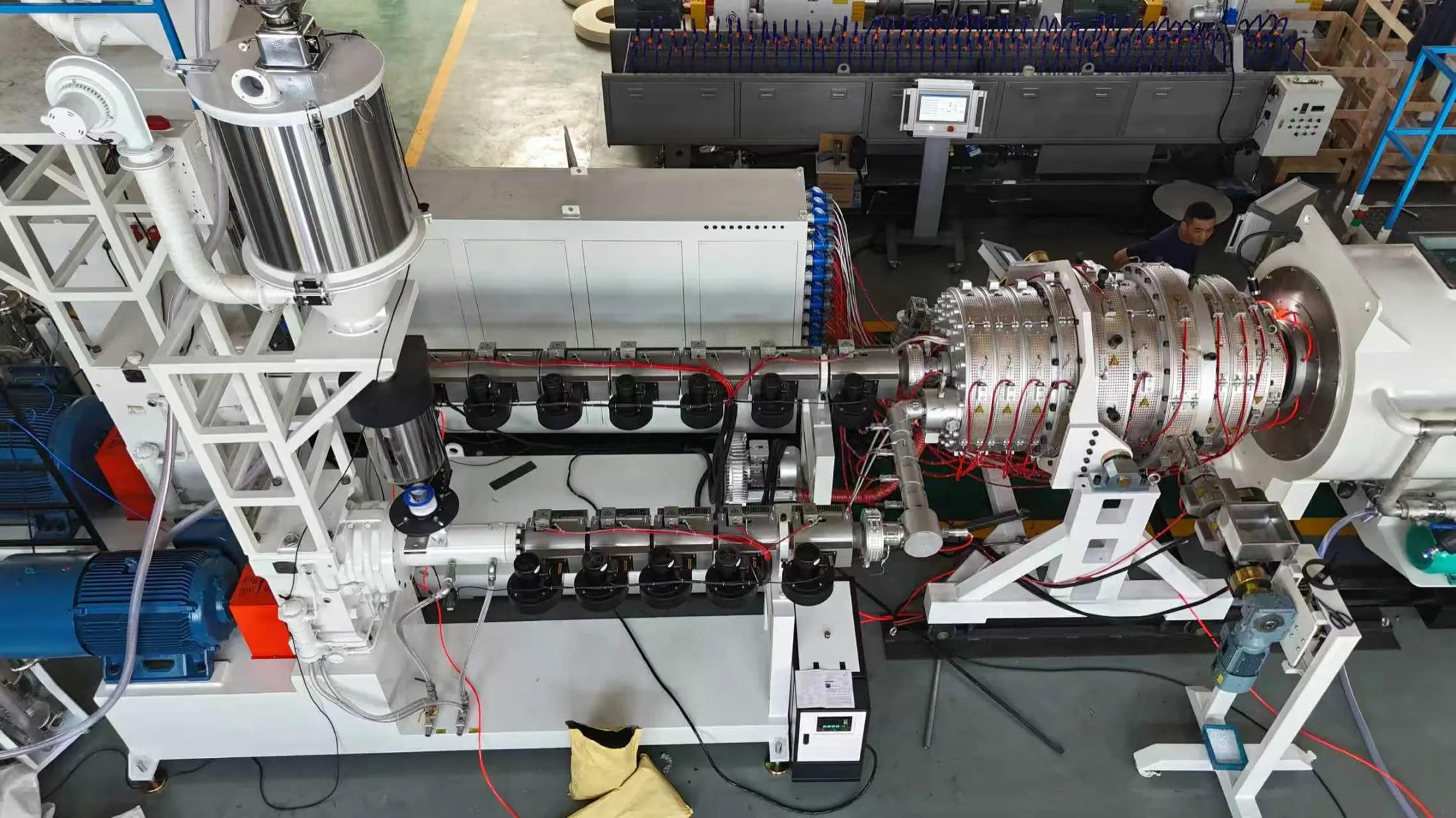 Top view of HDPE pipe extruder barrel and die head during factory testing