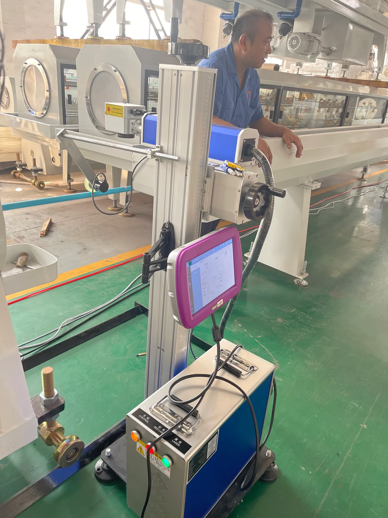 Laser printer installed beside plastic pipe extrusion line for online coding