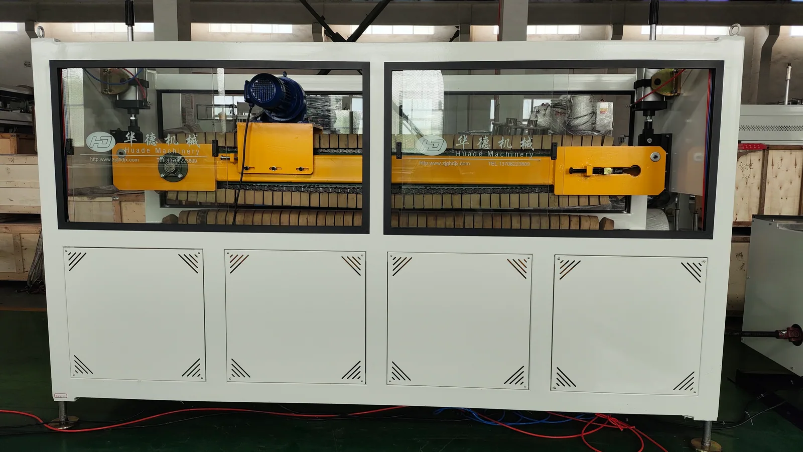 Haul-off machine pulling PVC window frame profiles after calibration
