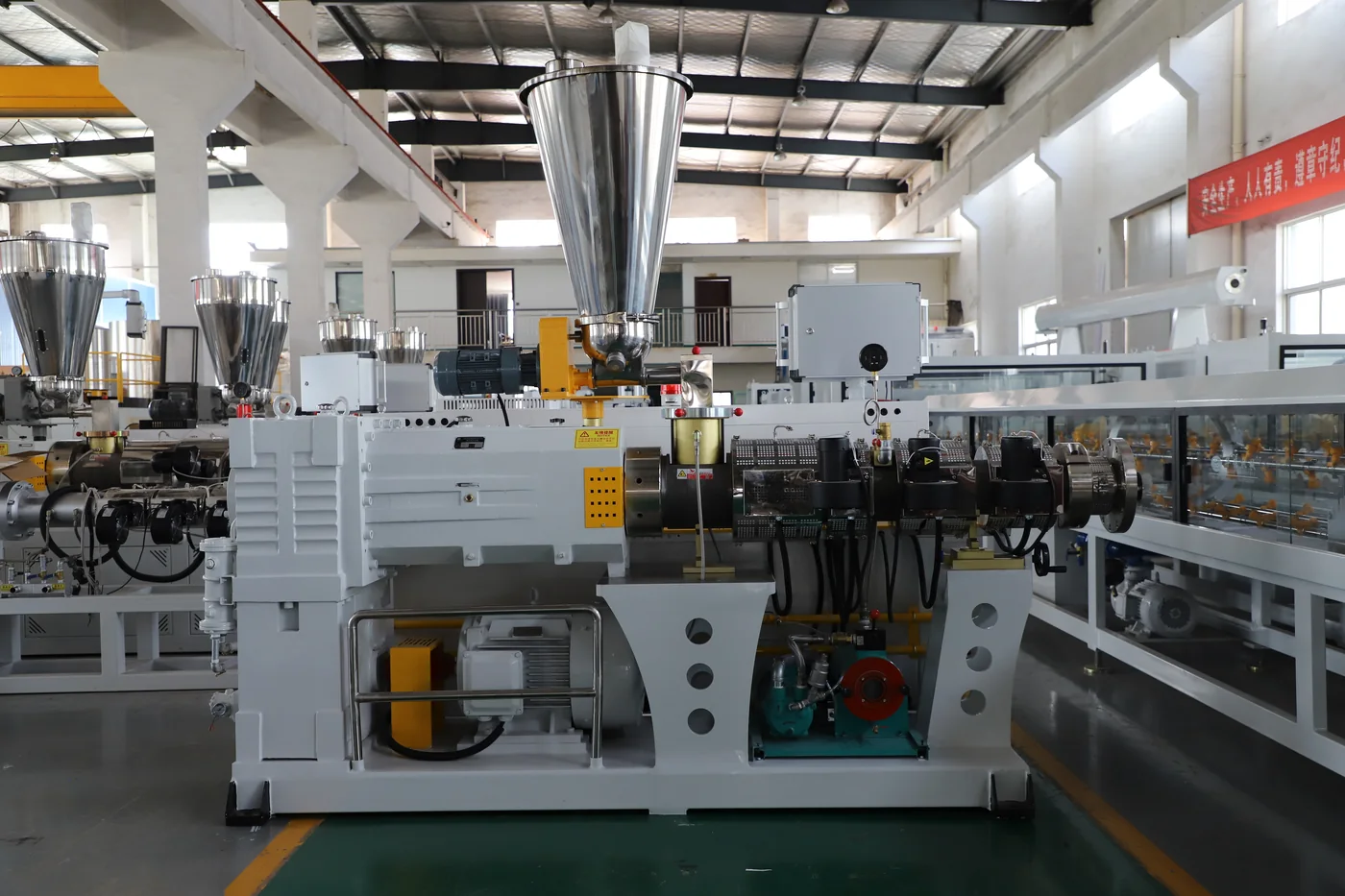Twin screw extruder machine overview with hopper, barrel, gearbox and motor